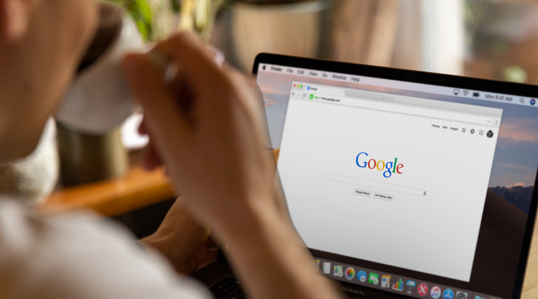 Woman drinking coffee navigating Google updates